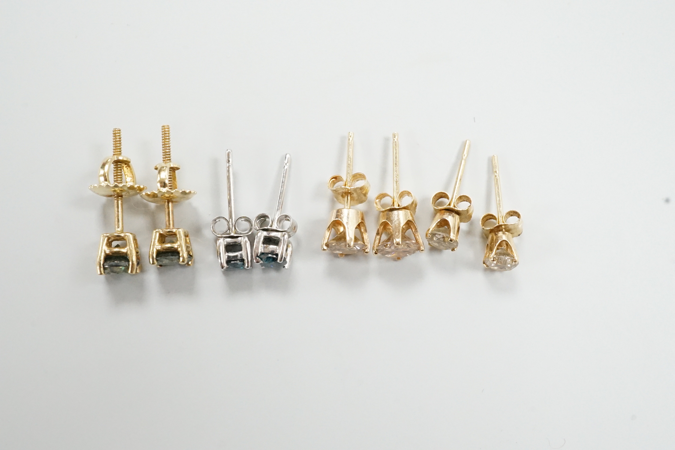 Four assorted pairs of yellow or white metal and diamond set ear studs, including coloured stones.